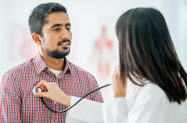 Stock photo of doctor listening to patient's lung